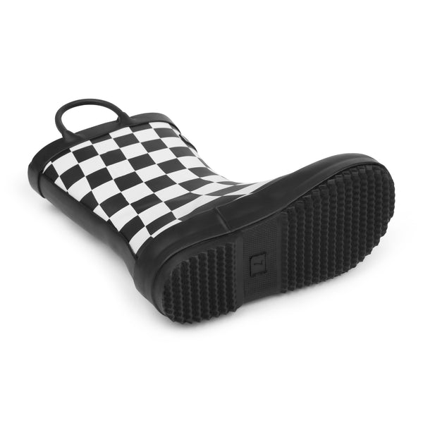 Detail image of black and white checkered colored children's rain boot focusing on the sole with texture and size stamped into the bottom on a white background.