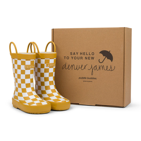 Golden and white checkered rain boots with a cardboard box branded with 'Denver James' on a white background.