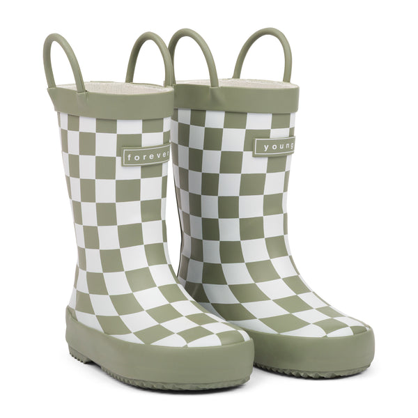 Front 3/4 view of green and white checkered children's rain boots with 'forever young' branding and grip handles for easy slip on, on a white background.
