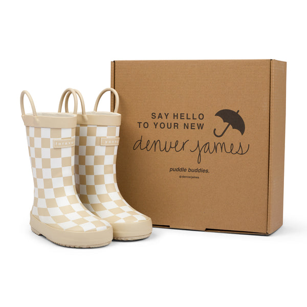 Tan and white checkered rain boots with a cardboard box branded with 'Denver James' on a white background.