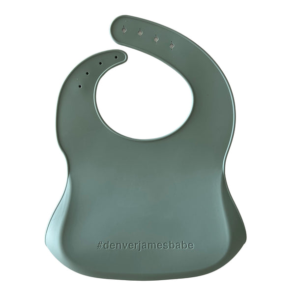 Back view of a seafoam silicone bib on a white background with '#denverjamesbabe' text.