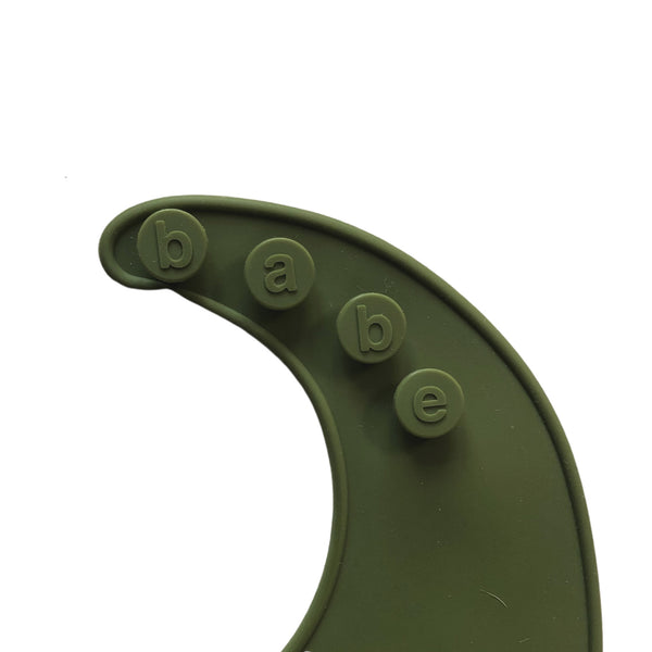 detail image of a bright green silicone bib on a white background with 'babe' buttons.