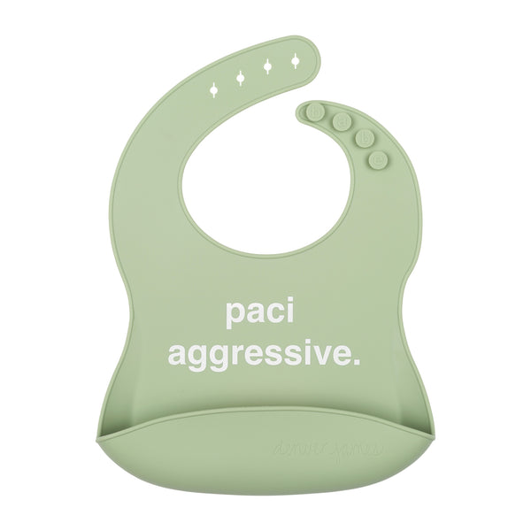 Front View of a light green silicone food catcher bib with 'paci aggressive.' text on a white background.