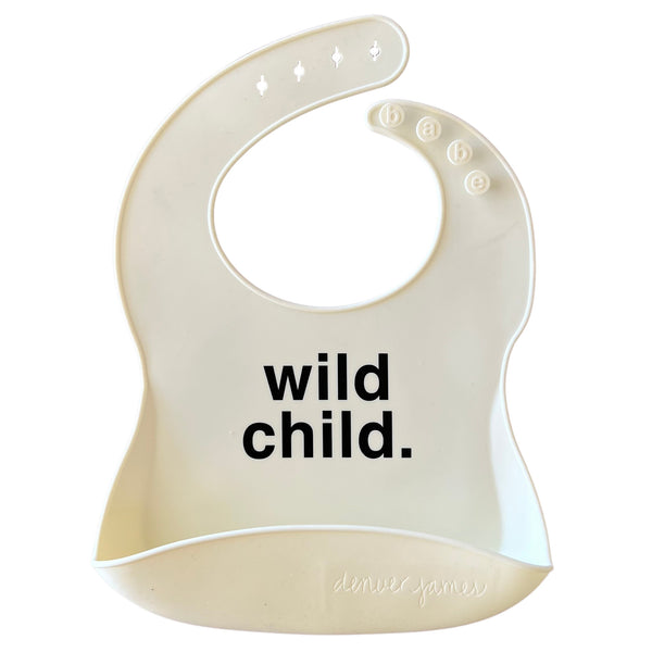 Front View of a white silicone food catcher bib with black 'wild child.' text on a white background.
