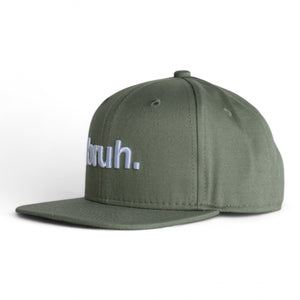 Front 3/4 view of a  green 6 panel classic ball cap with the word 'bruh.' embroidered on the front on a white backdrop. 