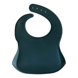 Back view of a dark green Silicone bib on a white background with '#denverjamesbabe' text.