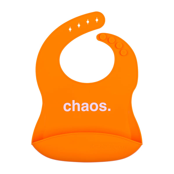 Front View of a bright orange silicone food catcher bib with 'chaos.' text on a white background.