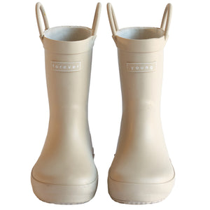 Front view of a pair of sand colored rain boots for children. Showing pull handles for easy slip on and tags that say "Forever Young" on the front. 
