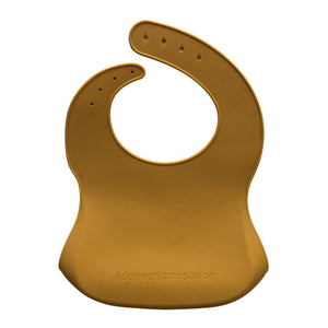 Back view of a dark orange silicone bib on a white background with '#denverjamesbabe' text.