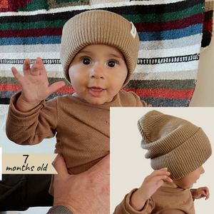 Light Brown | lifestyle image showing baby wearing beanie. 