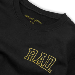 Detail view of kids black sweatshirt that says 'Rad.' on a white background. 