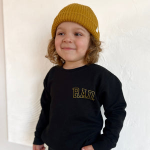 boy with long hair wearing beanie and 'Rad' Sweatshirt