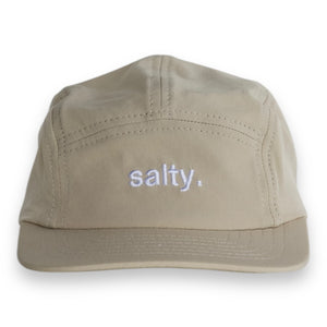 front view of a tan five-panel cap with the words 'salty.' embroidered on the front.