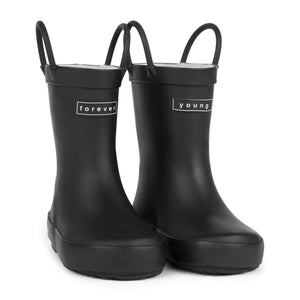 Front 3/4 view of a pair of black colored rain boots for children. Showing pull handles for easy slip on and tags that say "Forever Young" on the front. 