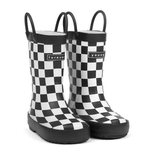Front 3/4 view of Black and white checkered children's rain boots with 'forever young' branding on a white background