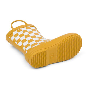 Detail image of golden and white checkered colored children's rain boot focusing on the sole with texture and size stamped into the bottom on a white background. 
