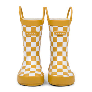 Front view of golden and white checkered children's rain boots with 'forever young' branding on a white background.