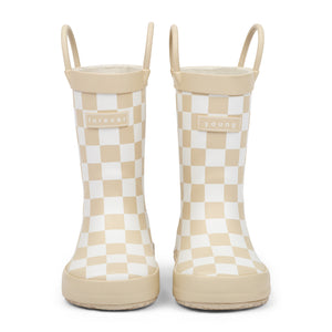 Front view of tan and white checkered children's rain boots with 'forever young' branding and grip handles for easy slip on, on a white background.