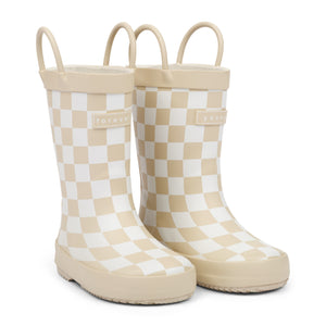 Front 3/4 view of tan and white checkered children's rain boots with 'forever young' branding and grip handles for easy slip on, on a white background.