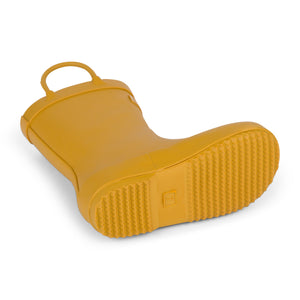 Detail image of golden colored children's rain boot focusing on the sole with texture and size stamped into the bottom. 