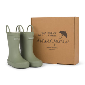 Sage colored children's rain boots with a cardboard box branded with 'Denver James' on a white background. 