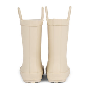 Back view of a pair of sand colored rain boots for children on white. Showing pull handles for easy slip on. 