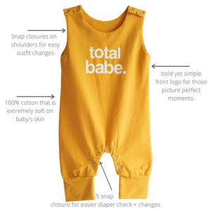 gold colored baby romper with text describing it's features. 