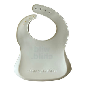 Back view of a white silicone bib on a white background with '#denverjamesbabe' text.