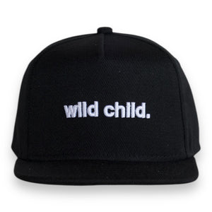 Front view of a  black 5 panel classic ball cap with the words 'wild child.' embroidered on the front.