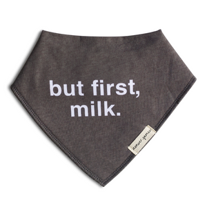 Gray bandana bib with 'but first, milk.' text on a white background