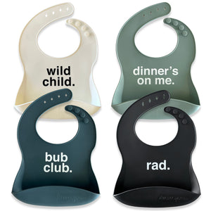Wild Child.  Dinner's On Me. Bub Club.  Rad. Silicone bibs on a white background with humorous text. 